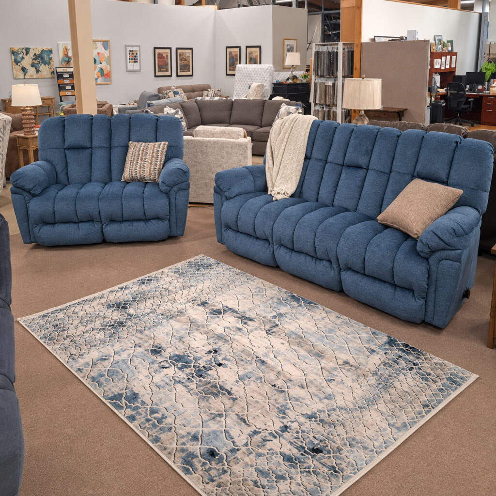 Blue Best Home Furnishings reclining sofa and loveseat with deeply padded cushions.