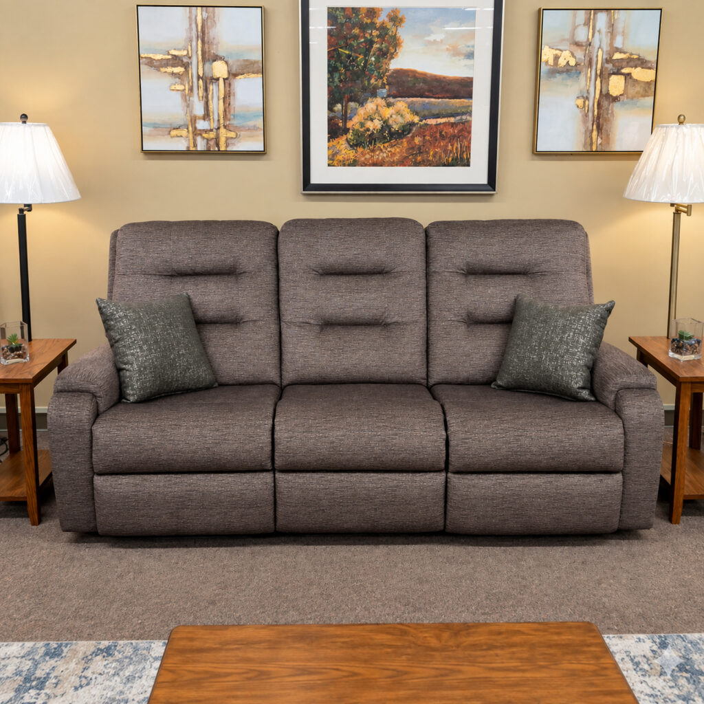 Gray Flexsteel reclining sofa with divided back cushions and two dark accent pillows.