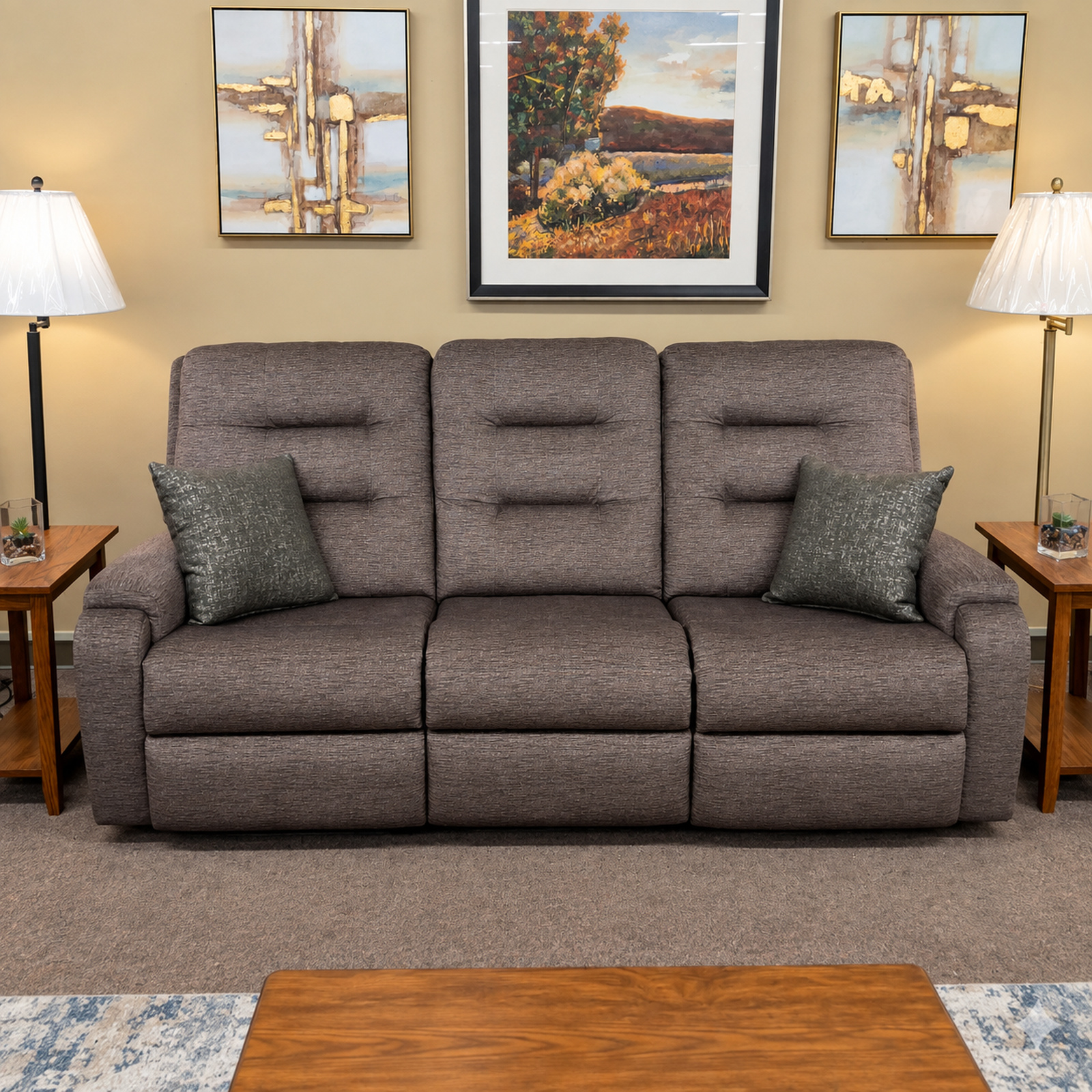Gray Flexsteel reclining sofa with divided back cushions and two dark accent pillows.