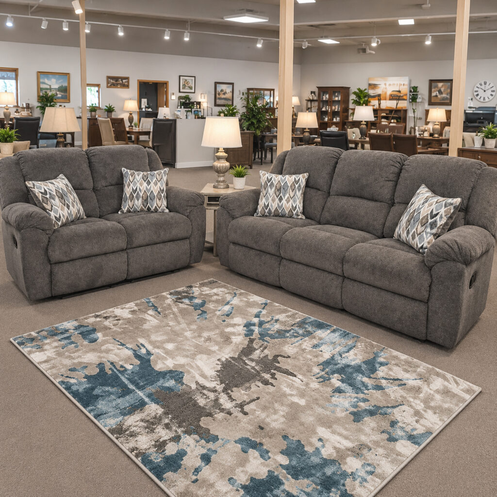 Gray Homestretch reclining sofa and loveseat with padded arms and patterned pillows.