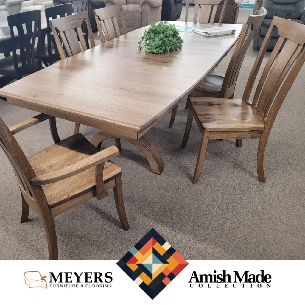 Amish Made dining table with warm brown wood finish and arched base at Meyers Furniture.