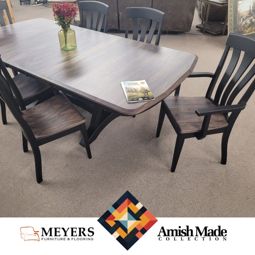 Amish Made dining table with dark wood top and black chairs at Meyers Furniture
