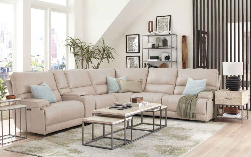 Light neutral Parker House sectional styled in a bright living room with soft pillows, throw blanket, and modern tables.