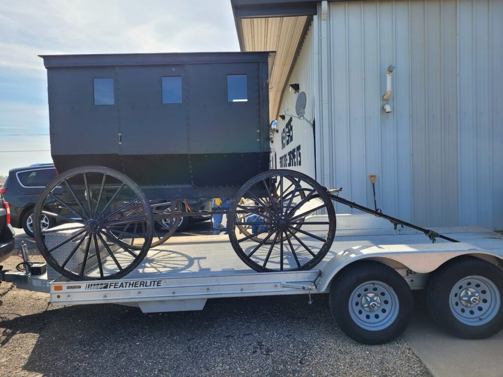 Amish buggy arriving at Meyers Furniture & Flooring in Mendota on a trailer