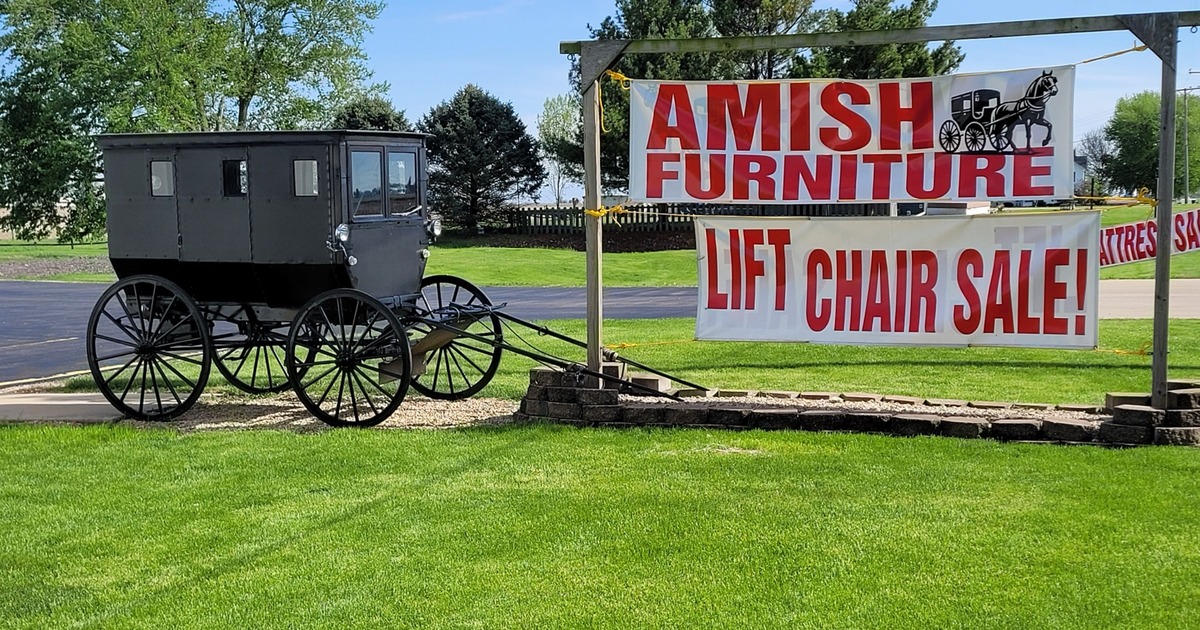 Amish buggy displayed outside Meyers Furniture & Flooring in Mendota beside an Amish Furniture sign
