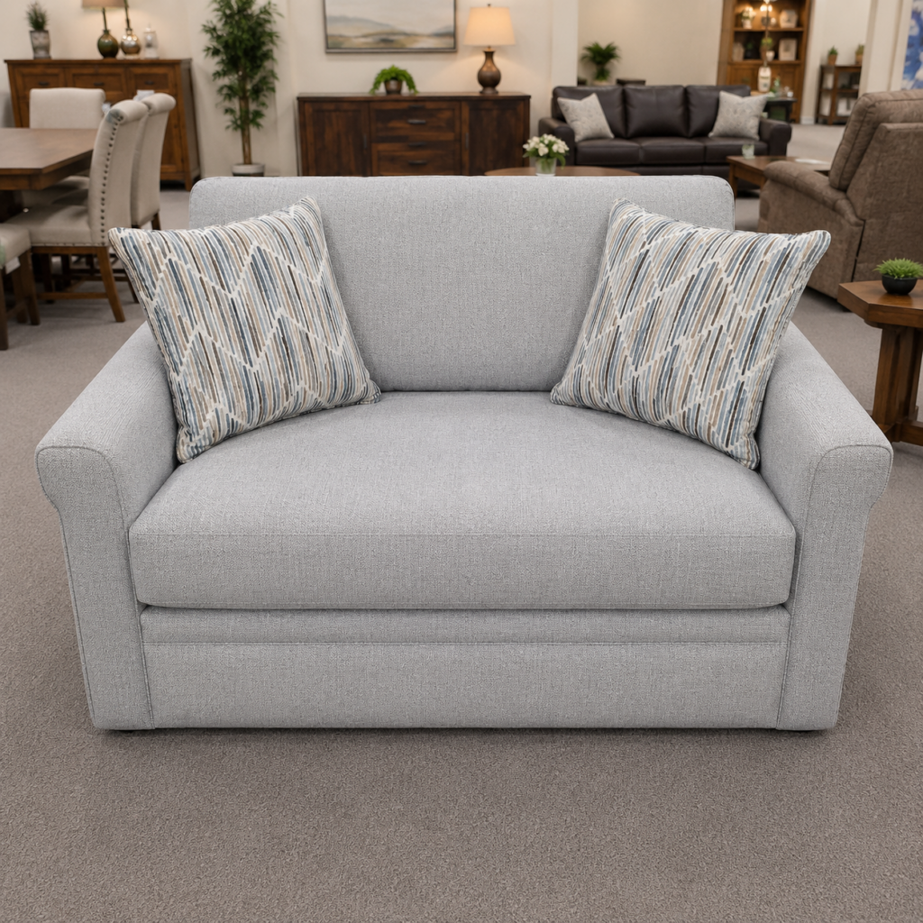 Light gray twin sleeper sofa with patterned pillows at Meyers Furniture in Mendota.