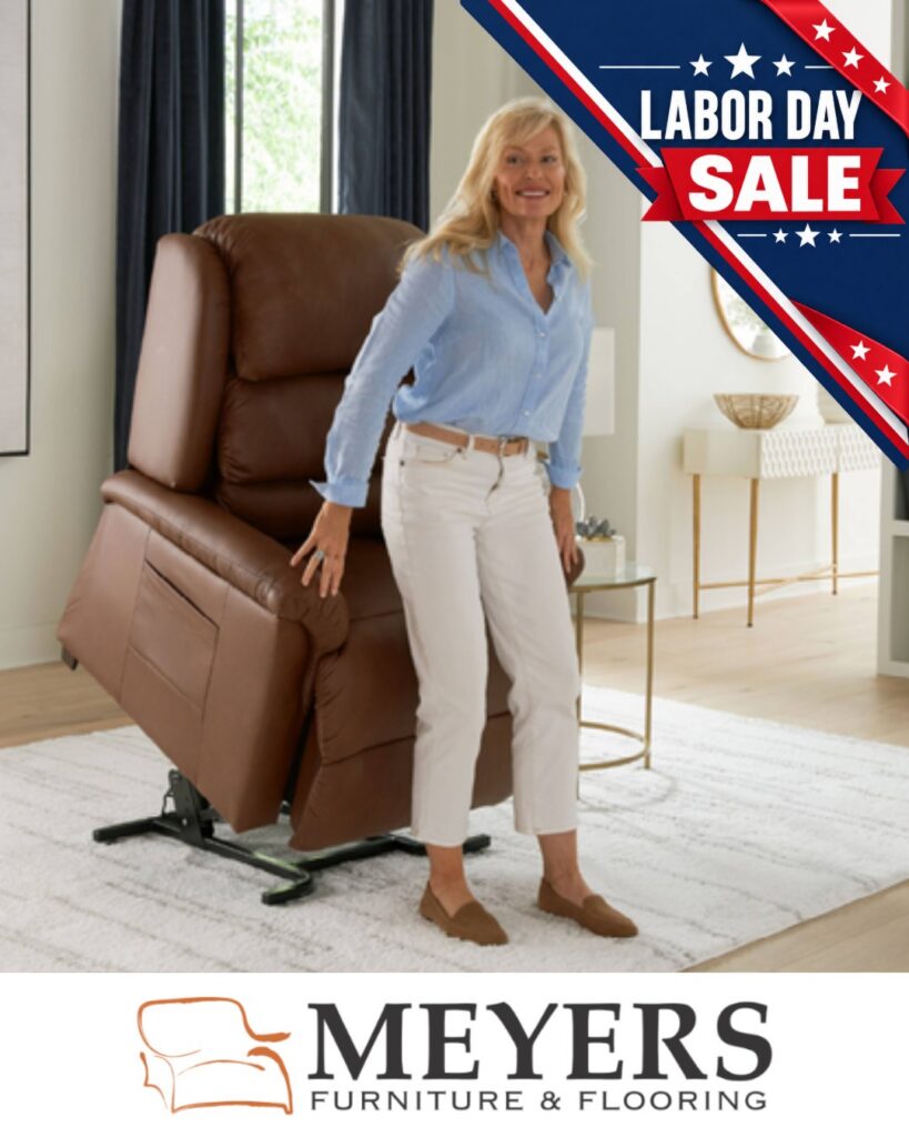 Woman standing beside a brown power lift recliner