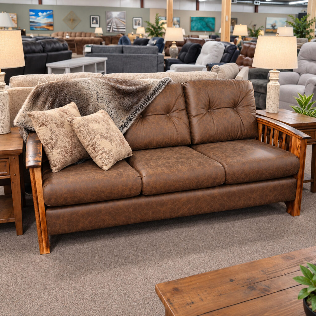Brown Best Craft sofa with exposed wood arms, tufted cushions, patterned pillows, and a throw.
