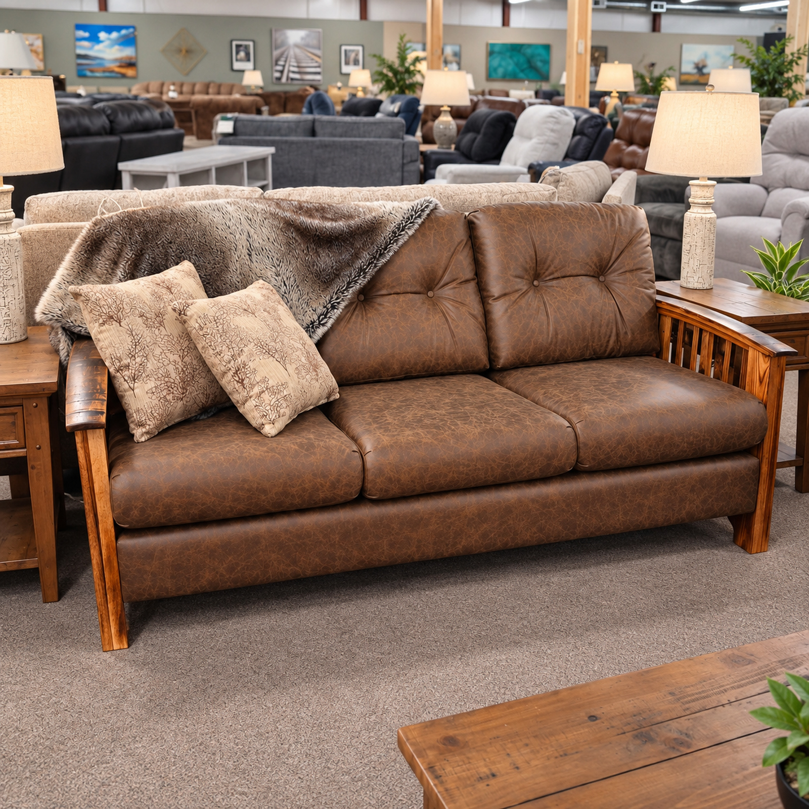 Brown Best Craft sofa with exposed wood arms, tufted cushions, patterned pillows, and a throw.
